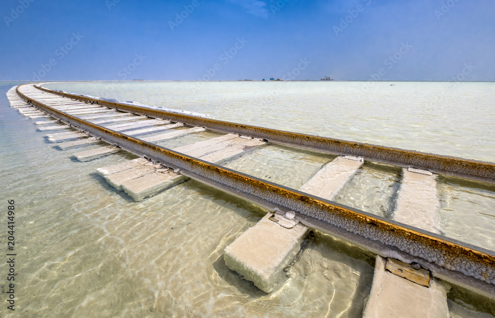 The railway laid on top of the salt lake in the water