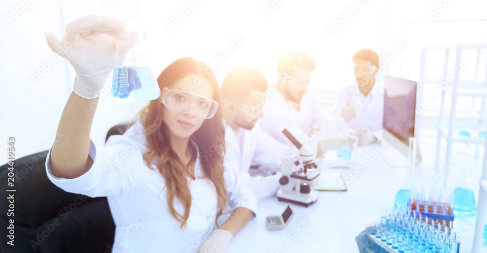 group of young scientists working in the laboratory. group of young scientists working in the laboratory.