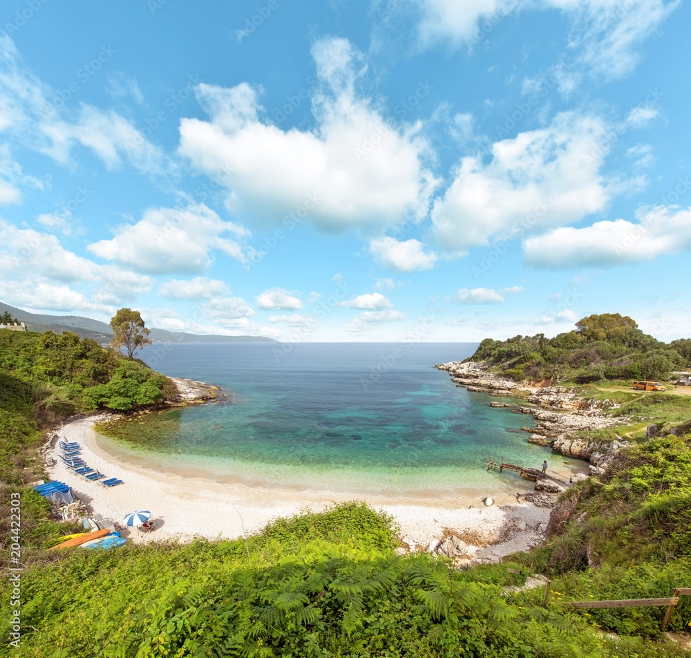 Fabulous beautiful magic landscape with clouds over Pipitou Beach near Kanoni Beach on the coast of the Ionian Sea in Corfu, Greece. Amazing places. Tourist Attractions.