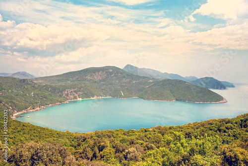 magical beautiful landscape with clouds over a hilly bay in the Ionian Sea in Greece.