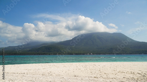 Seascape ocean,mountains and beautiful beach paradise. Beach, sea, sand,wave. Tropical beach, blue sky, clouds Philippines Camiguin Travel concept © Alex Traveler