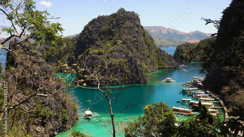 Tropical lagoon with azure water, beach by the Kayangan Lake, Philippines. View Coron island, with cove, bay at Kayangan lake. Lagoon with sailing boats. Philippines. Travel concept © Alex Traveler