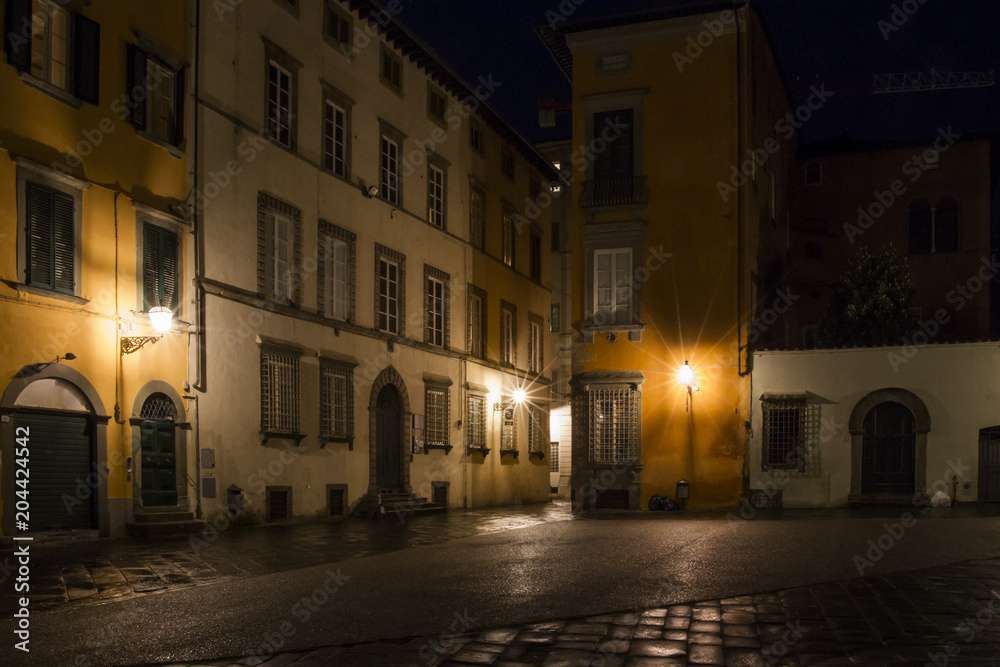 Nocturnal Old Town streets with street lighting in the Tuscan city of Lucca in Italy