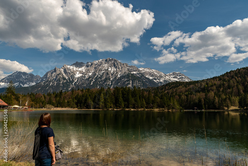 A girl looking to the alps on the Lautersee