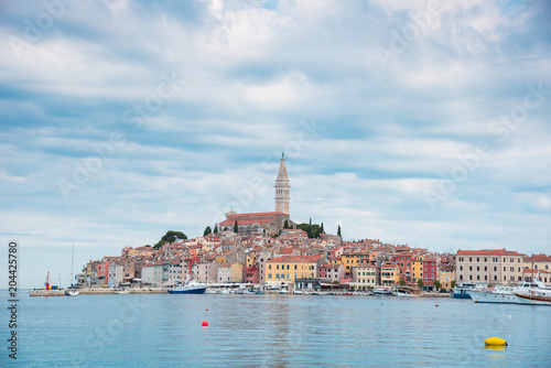 Beautiful city landscape with sea boats, colorful houses and an ancient tower in Rovinj, Croatia, Europe. (vacation, rest - concept)