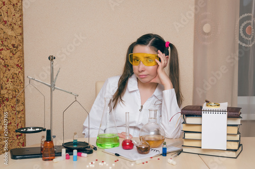 Emotional student girl on chemistry lesson. Pharmacist or apothecary woman. Scientific experiment background. Funny intern in chemical laboratory concept.