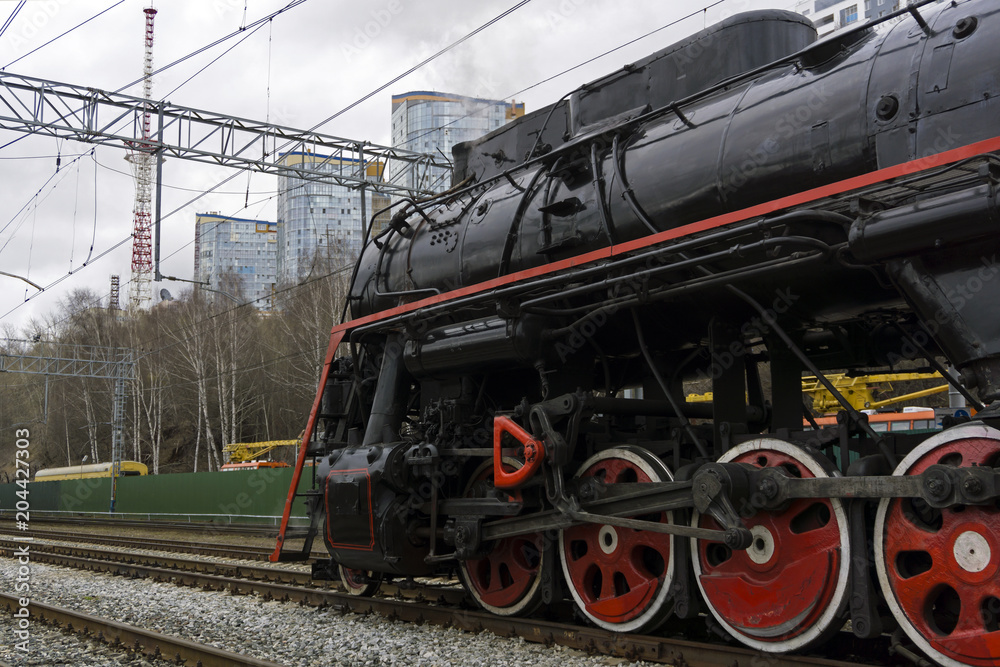 active retro steam locomotive on the shunting tracks of the modern railway station active retro steam locomotive on the shunting tracks of the modern railway station