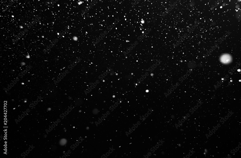 Obraz premium snow on black background, white spots on black