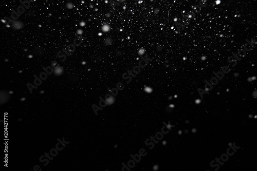 white snow on a black background