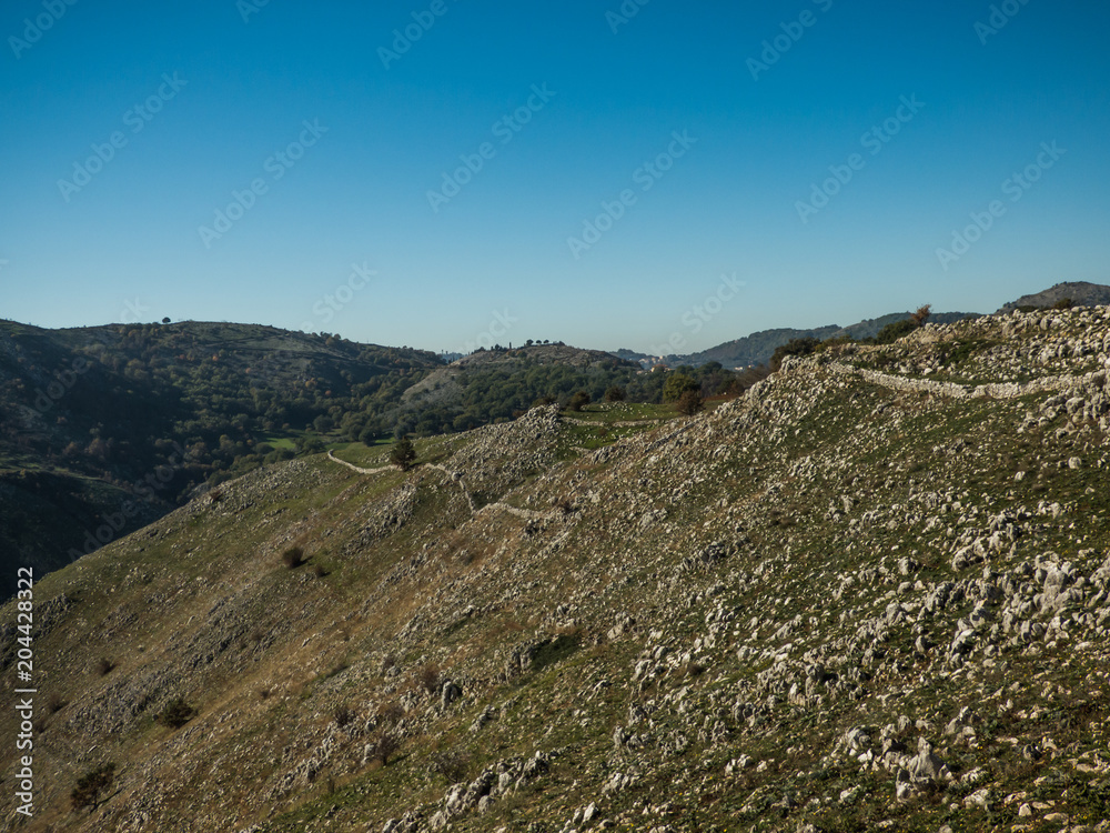 Blue sky and mountain side