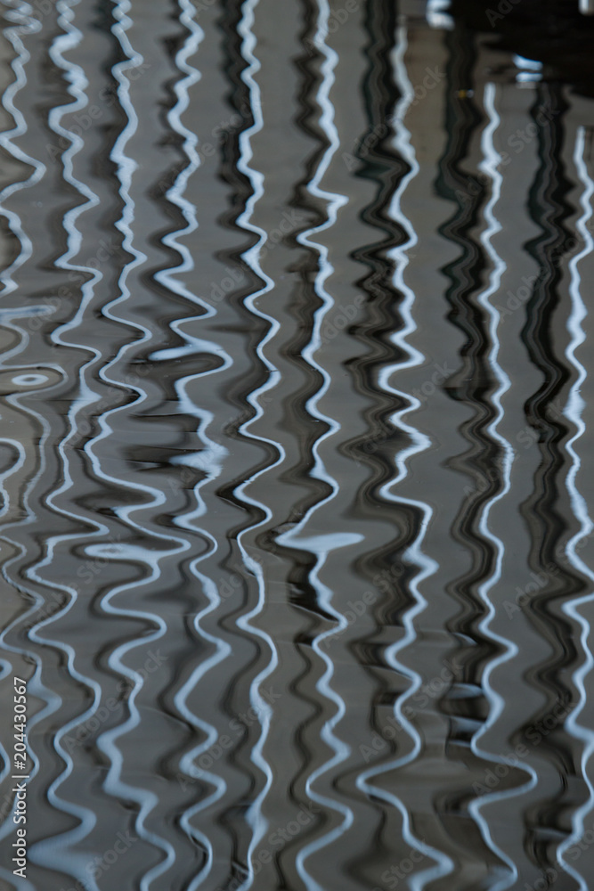 Reflections pattern over ripple water surface. Abstract background photo texture. Reflections pattern over ripple water surface. Abstract background photo texture.