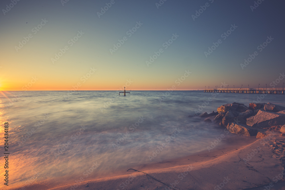 Fototapeta premium Amazing sunrise on the pier at the seaside. Gdynia Orlowo, Poland