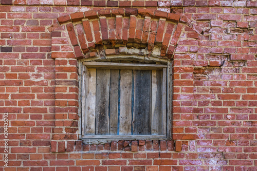 old broken window on brick wall background