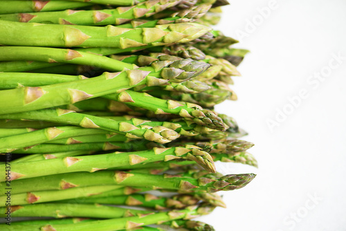 Green fresh asparagus on gray background. Top view. Raw, vegan, vegetarian and clean eating concept.