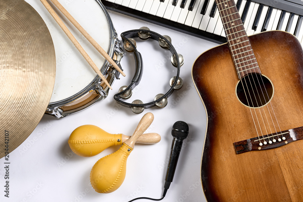 Naklejka premium a group of musical instruments including a guitar, drum, keyboard, tambourine.