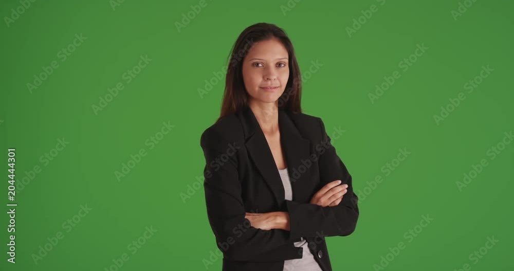 Happy business woman with arms crossed looking at camera on green screen Happy business woman with arms crossed looking at camera on green screen