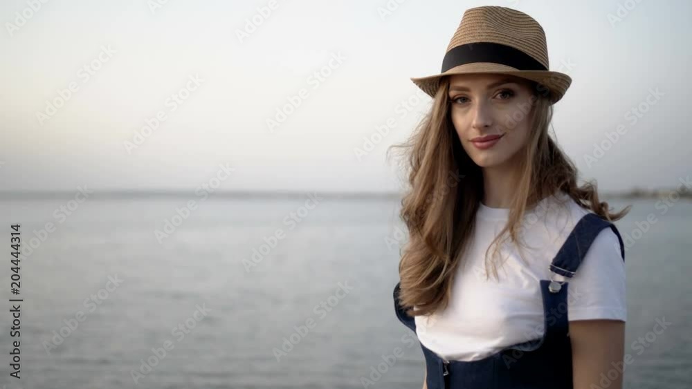 Attractive woman in a hat. Sunset Attractive woman in a hat. Sunset
