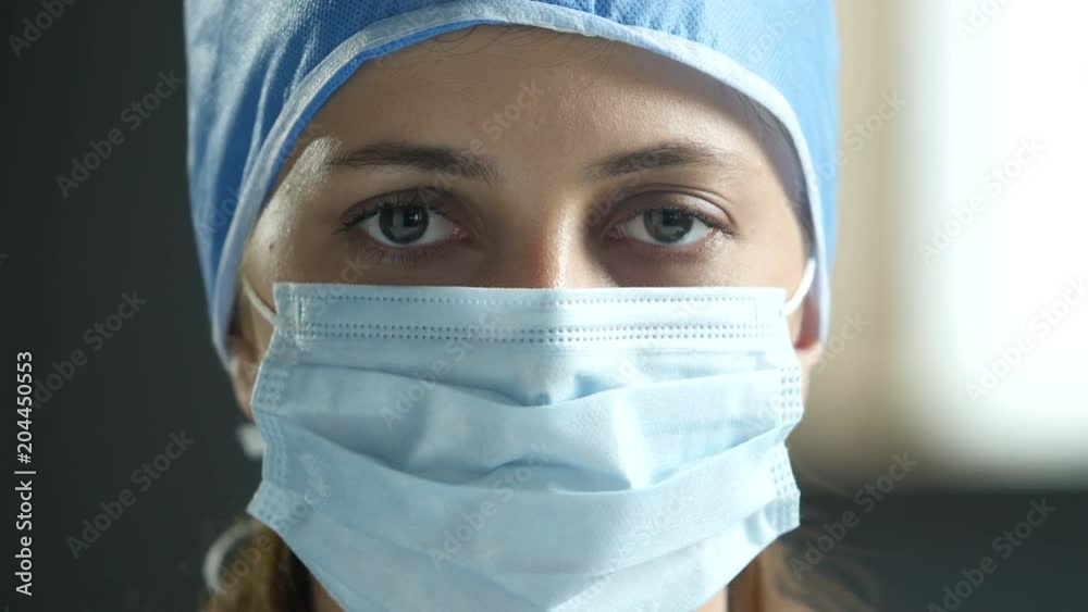 Surgeon wearing surgical mask and cap Surgeon wearing surgical mask and cap