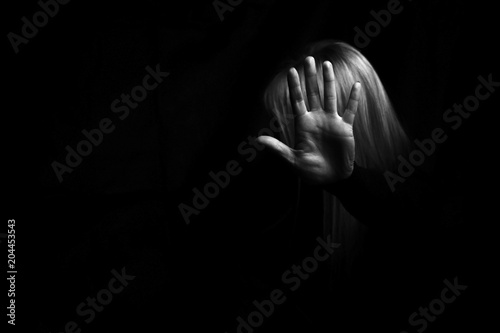 Woman's hand showing STOP gesture. Violence concept.  photo