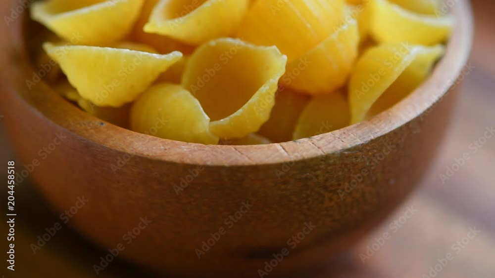 Uncooked macaroni pasta rotating background Uncooked macaroni pasta rotating background