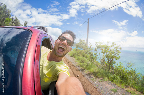 Handsome man taking a selfie at cartrip on vacation photo