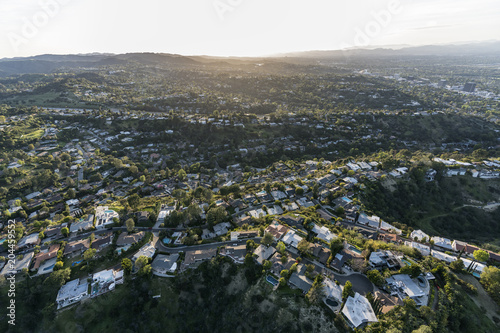 Aerial view of hillside and canyon homes in the Hollywood Hills above the San Fernando Valley in Los Angeles, California.