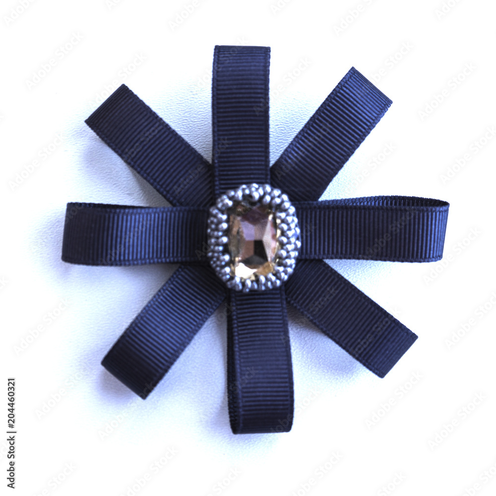 Handmade brooch from dark blue tapes and a rhinestone.