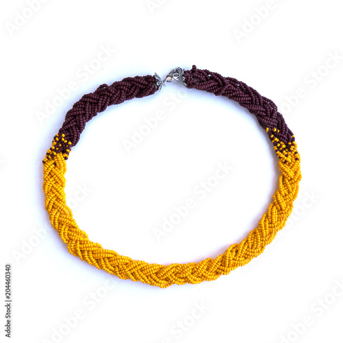 Bright handmade necklace braid from orange beads.