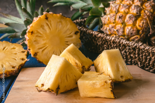 Close up of Pineapple fruit with slices on wooden tray