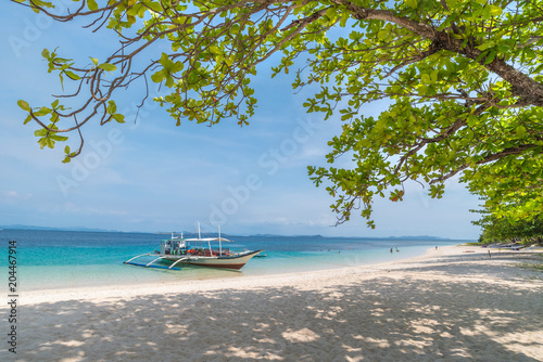 Tropical beach with boats on the Dibutonay Island, Busuanga, Palawan, Philippines. Beautiful tropical island with sand beach. Travel concept