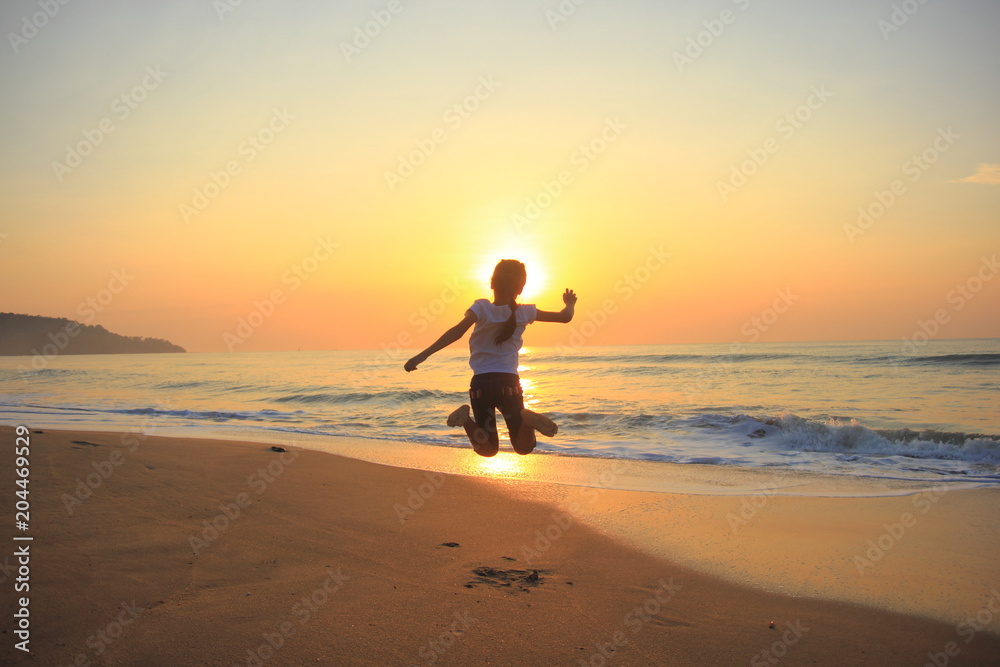 flying jump beach child girl on the beach in summer holiday, on sunset time.Happy little girl on the beach.soft focus