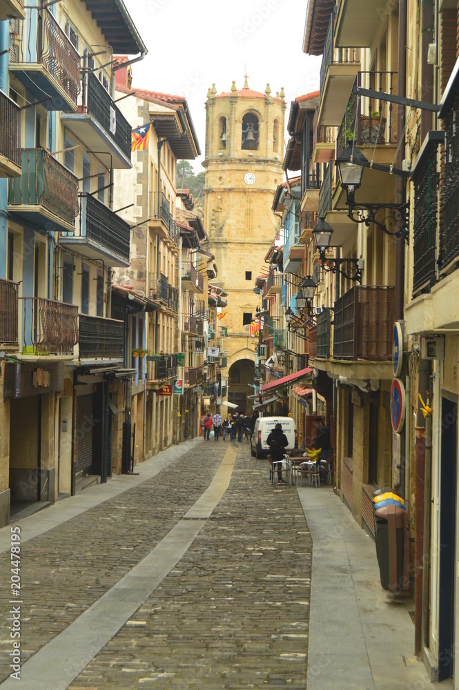 Beautiful Main Street Of The Fortified Town Of Getaria To The Bottom You Can See Its Beautiful Cathedral. Architecture Middle Ages Travel. March 26, 2018. Getaria Guipuzcoa Basque Country Spain.