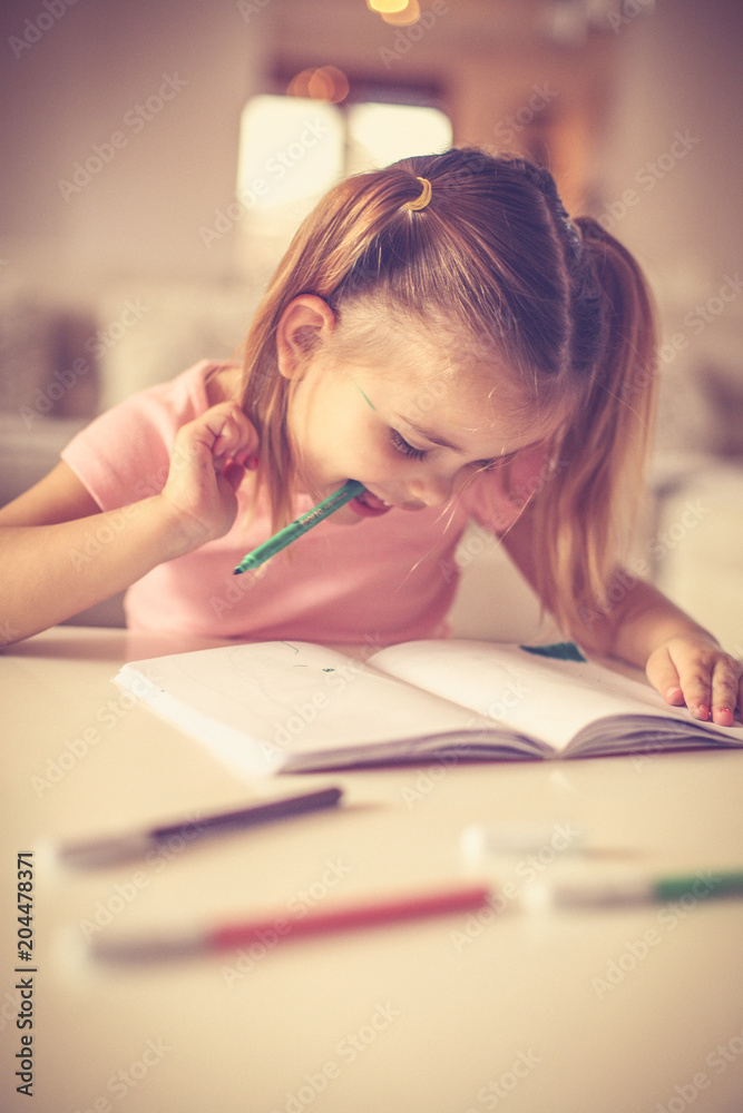 Try to draw with pencil in mouth. Little girl. Try to draw with pencil in mouth. Little girl.