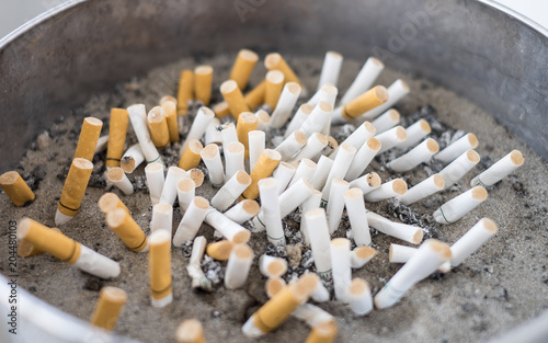 The cigarette butts are left in the cigarette binใ Smoking causes bad health for the body.