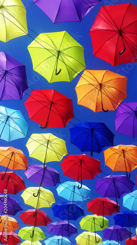 multicolored umbrellas flying in sky 