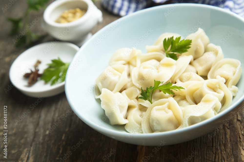 Homemade Russian dumplings served with parsley
