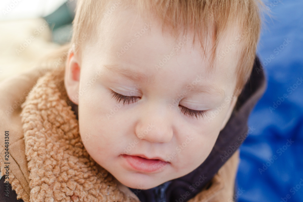 the face of a small child with closed eyes and long eyelashes the face of a small child with closed eyes and long eyelashes
