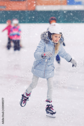 Caucasian girl at ice skating ring