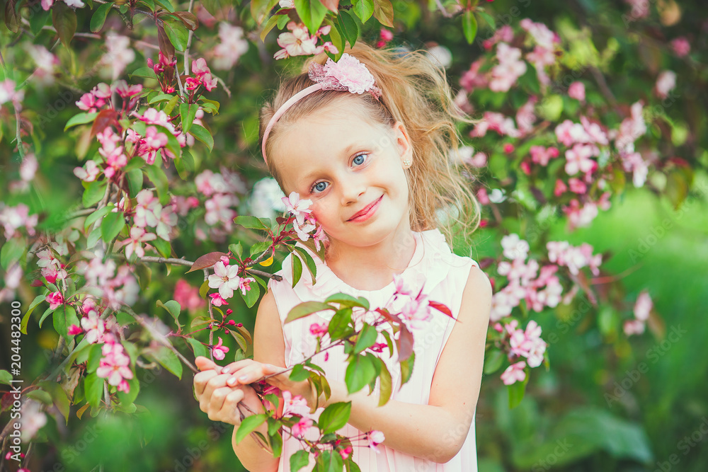 Cute spring fashion girl under blossom apple tree Cute spring fashion girl under blossom apple tree
