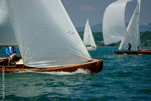 Classic sailing boats racing at a regatta at lake constance