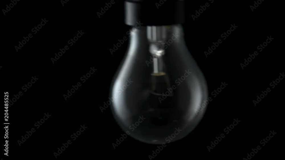 Light bulb flickering and swinging. 4k Black background Light bulb flickering and swinging. 4k Black background