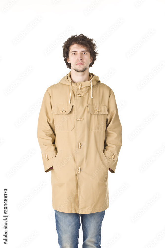 Nice young guy in raincoat looking to cameraman Nice young guy in raincoat looking to cameraman