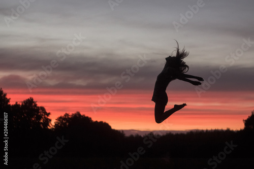 jumping person against the background of the sunset