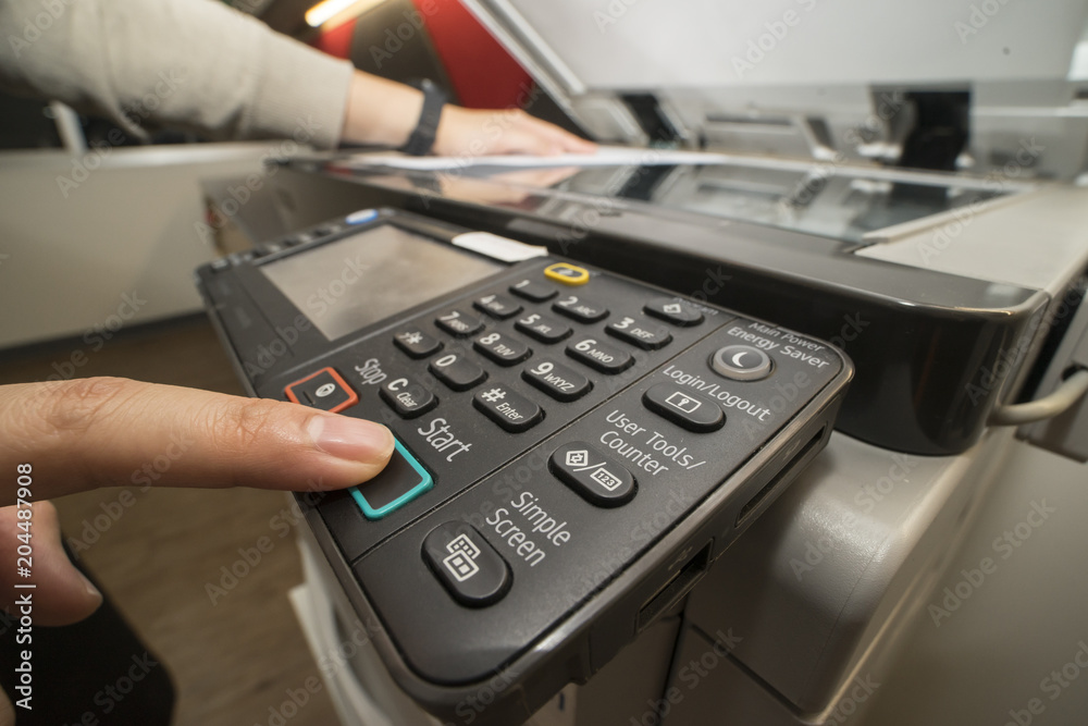 Man pushing copy button to copying paper from Photocopier Man pushing copy button to copying paper from Photocopier