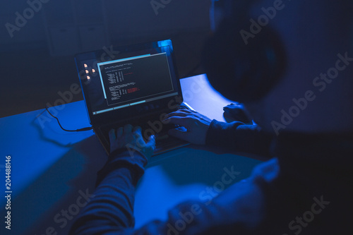 Konstfotografi cybercrime, hacking and technology concept - male hacker with headphones and cod