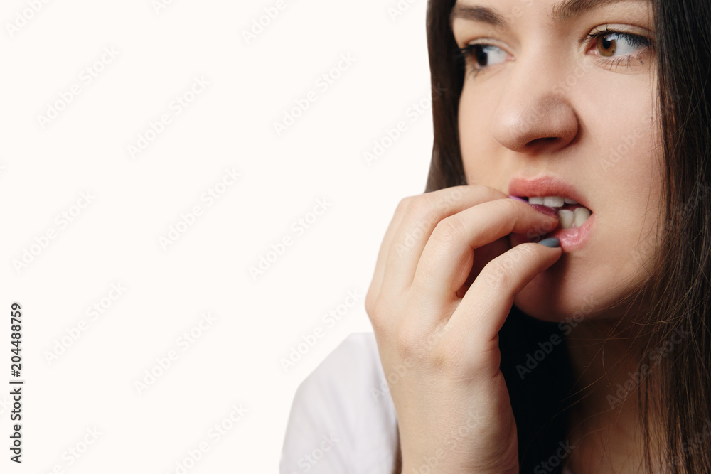 woman gnawing nails close-up, nervous, psychosis, white background woman gnawing nails close-up, nervous, psychosis, white background