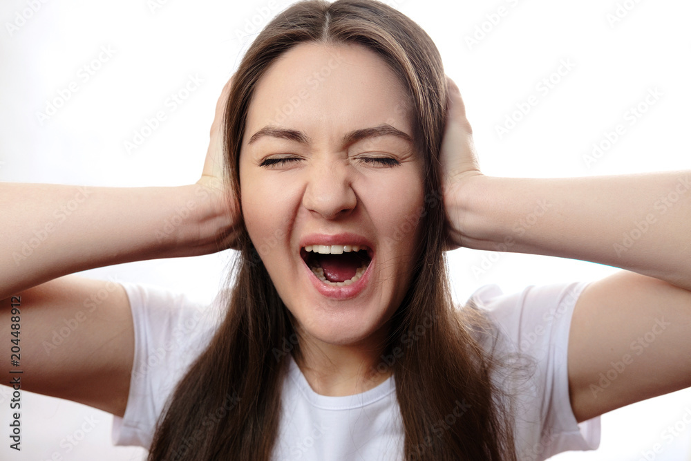 girl covers her ears with her hands, screams, headache girl covers her ears with her hands, screams, headache