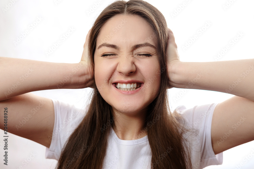 girl covers her ears with her hands, headache girl covers her ears with her hands, headache