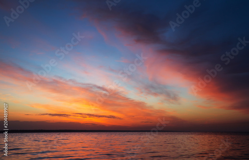 Magic orange sunset over sea. Sunrise over Beach © es0lex