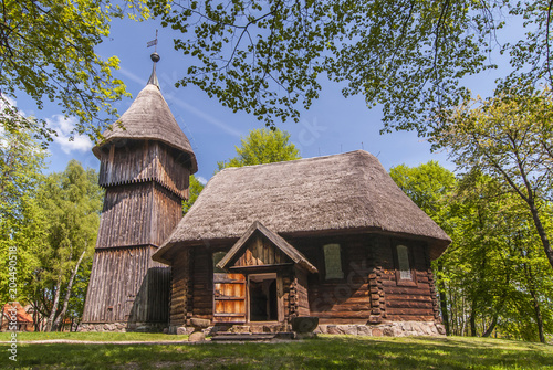 Old wooden evangelic church with and wooden belfry, both from Masuria region, Ethnographic Park in Olsztynek, Poland. photo